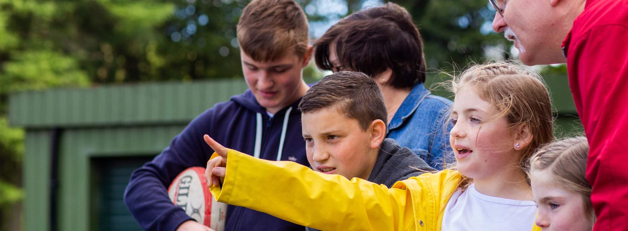 A young girl pointing at something off camera